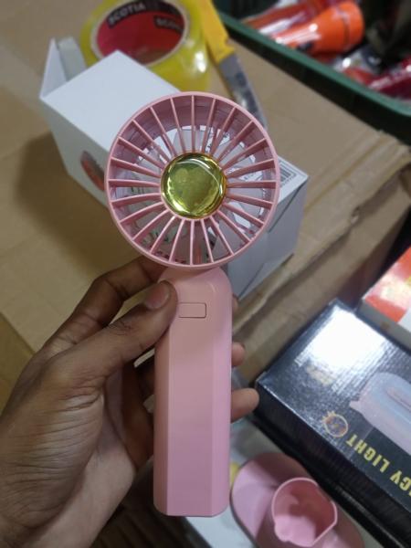 Handy Phone Mini Fan Y03 is a portable, rechargeable handheld fan designed for personal cooling